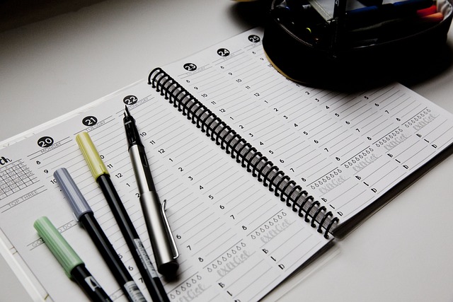 Close up on a spiral ring agenda and pens