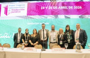 people standing together at a conference in front of a screen