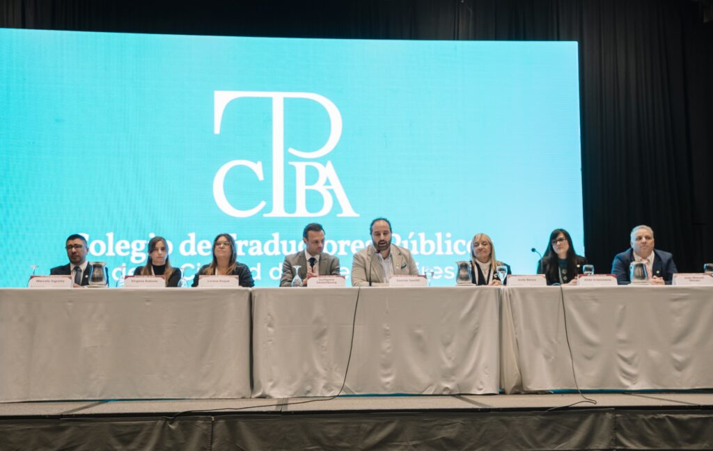 people sitting at a conference table facing the audience
