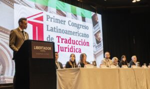 a man standing and addressing a conference 